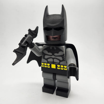Batman-inspired oversized brick-style display figure holding batarang accessory