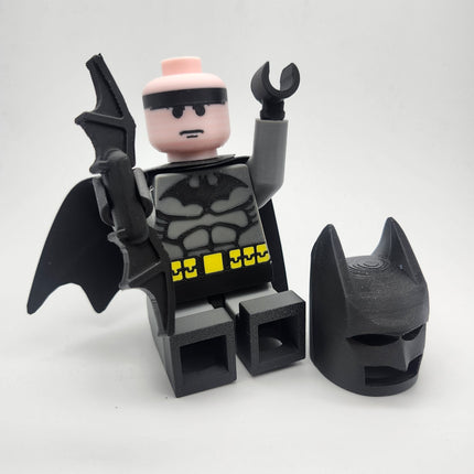 Oversized Batman-inspired brick-style display figure shown unmasked with cape and accessories