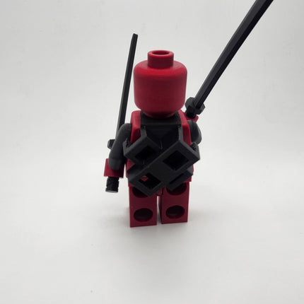 Rear view of Deadpool inspired oversized brick figure showing crossed sword holder