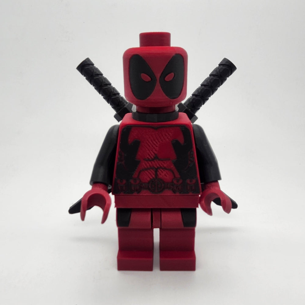Oversized Deadpool inspired red and black brick-style collectible with twin swords