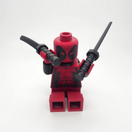 Deadpool inspired red and black oversized brick collectible posed with twin swords