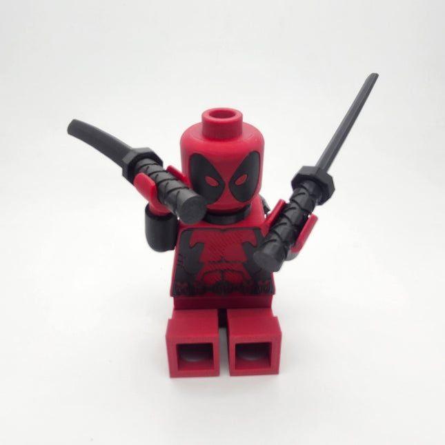 Deadpool inspired red and black oversized brick collectible posed with twin swords
