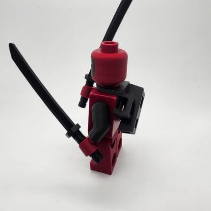 Side view of Deadpool inspired oversized brick figure with sword holder and black katana
