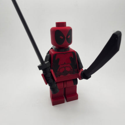 Deadpool inspired oversized brick figure posed holding two black sword accessories