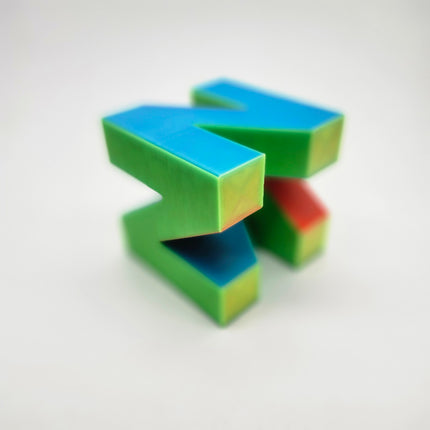 Angled view of multicolor N64 inspired glow in the dark display logo