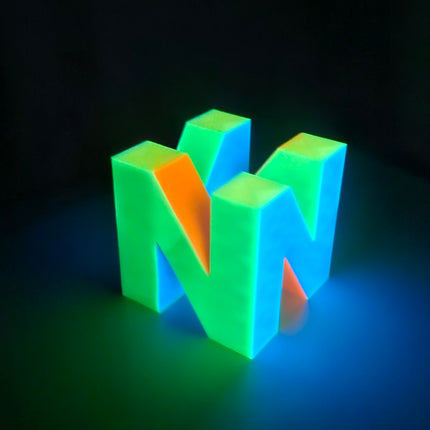 N64 inspired multicolor logo glowing brightly in the dark