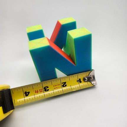 N64 inspired retro gaming logo shown with tape measure for approximate width