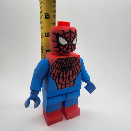 Oversized Spider-Man inspired brick figure shown with measuring tape at approximately 6 inches tall