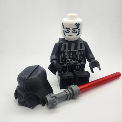 Darth Vader inspired oversized brick figure with removable helmet and red saber accessory displayed separately